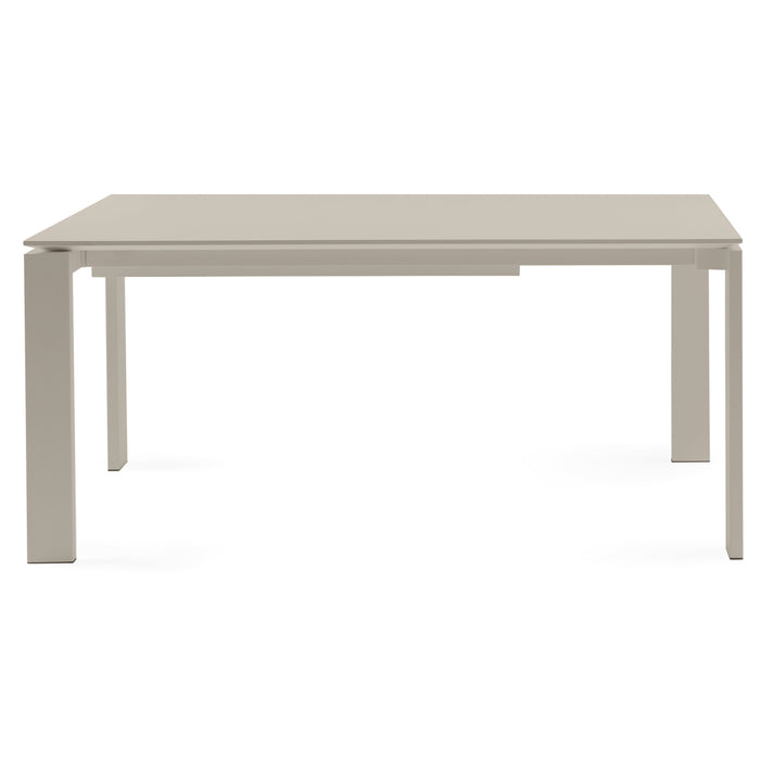 The Kartell Four Extendable Dining Table is a modern, rectangular table with a light beige top and four straight legs, displayed against a plain white background.