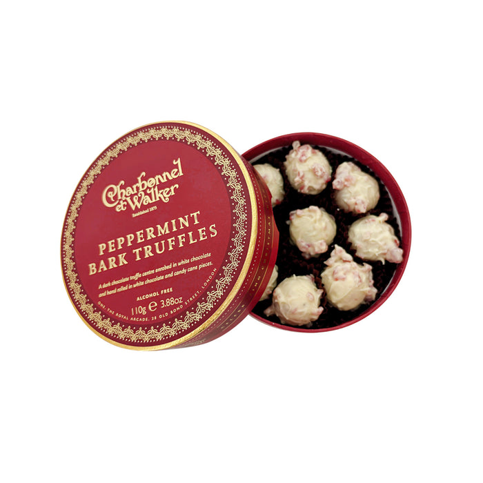 Round red Charbonnel & Walker Peppermint Bark Truffles, 110g gift box filled with white chocolate truffles sprinkled with peppermint pieces, with the lid resting beside it.