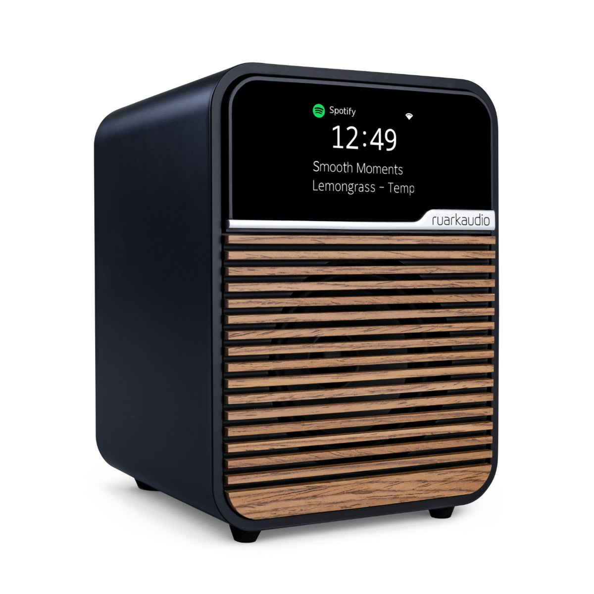 The Ruark R1S Smart Radio is a compact black and wood-finish speaker with a digital display showing the time (12:49) and Spotify info. The front features Ruark branding, emphasizing its Wi-Fi smart radio capabilities.