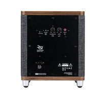 The Ruark RS1 Subwoofer by Ruark features a wood-accented back panel with control knobs, input ports, a power switch, and labels for premium audio and deep bass. It stands on four metal feet.