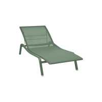 The Fermob Alize Sun Lounger features a green mesh seat and backrest, angled legs, and a minimalist look—ideal for outdoor relaxation. Shown on a plain white background.