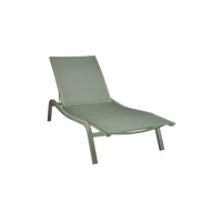 The Fermob Alize Sun Lounger XS in light green features a mesh fabric seat and backrest with a sleek, modern aluminium frame—ideal for outdoor relaxation. Shown on a plain white background.