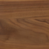 Close-up of a smooth, brown European walnut surface with distinctive grain patterns and natural color and texture variations, evoking the refined craftsmanship of the Eaton Dining Table by Ligne Roset.