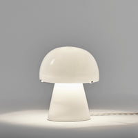 Serax Joe n°1 Table Lamp made of bone china, shaped like a mushroom with a glowing dome shade.