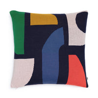 Square Bruten cushion by Sophie Home with a navy blue background and an abstract pattern of solid-colored geometric shapes in green, yellow, light pink, blue, and red.