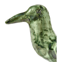 The Cosas Lindas Candle Holder by Serax features glossy green ceramic in the shape of a bird with carved details and a long beak, shown in profile against a white background—perfect as nature-inspired decor.