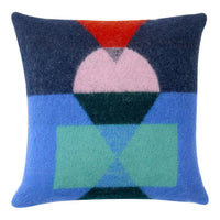 Shape Shift Cushion square lambswool throw pillow featuring a geometric pattern of overlapping red, pink, dark blue, light blue, and green colour block shapes.