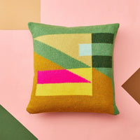 Tilt Cushion, Green, a square, pure new wool cushion featuring a geometric pattern of green, yellow, mustard, and bright pink shapes.