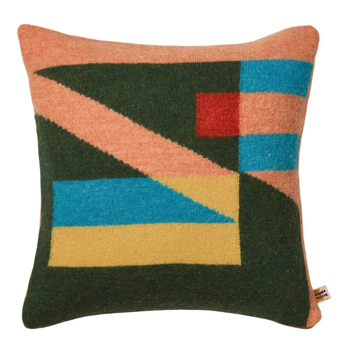 Donna Wilson Tilt Cushion, Peach: a square geometric cushion made in the UK, featuring a pattern of peach, olive green, blue, yellow, and red pure new wool blocks.