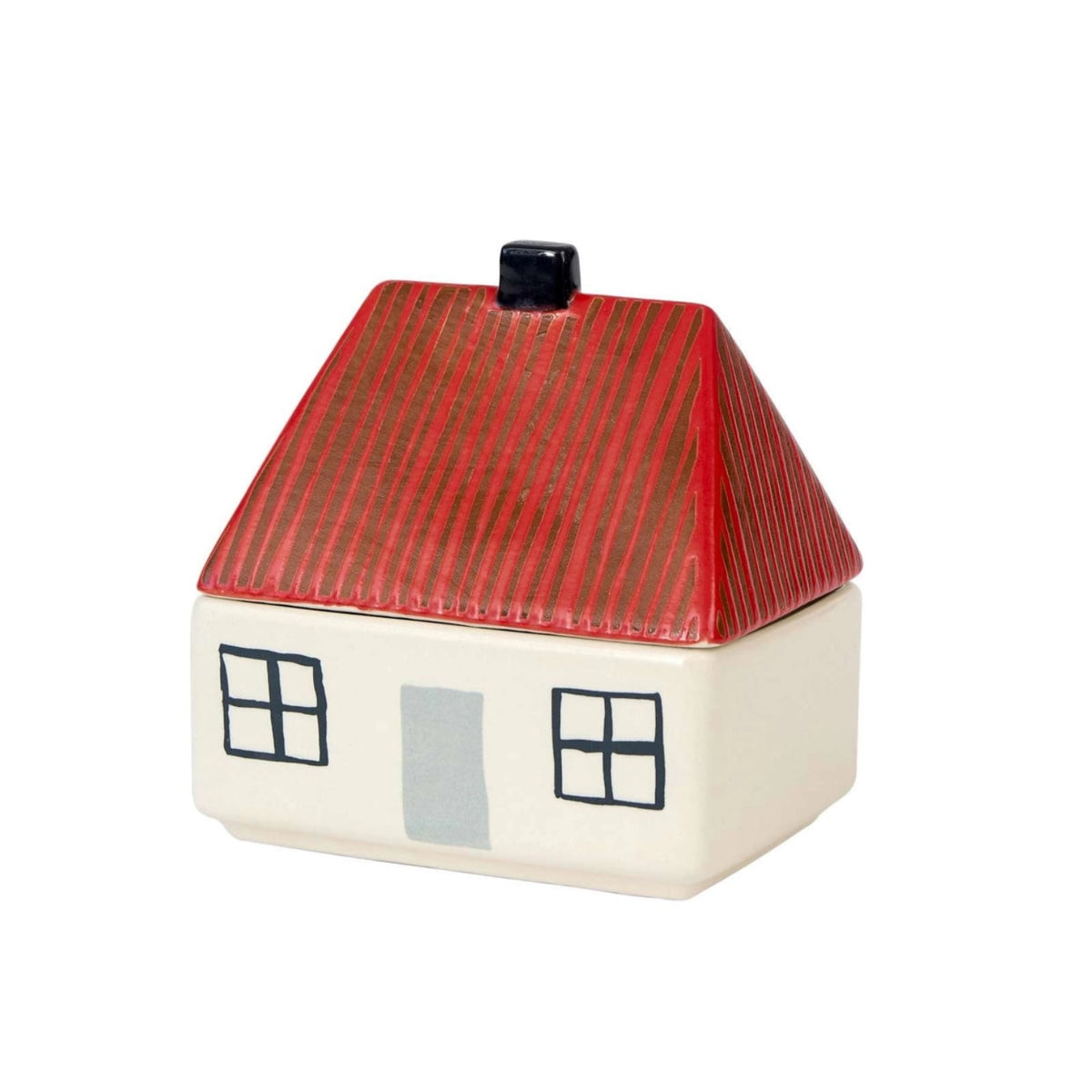 The Donna Wilson House Butter Dish by Donna Wilson features a charming stoneware house design with a red, ridged roof, white walls, two front windows, and a gray door—bringing playful character to your tabletop.