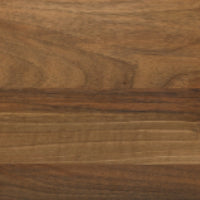 Close-up of a smooth European walnut surface with natural brown tones and horizontal grain patterns, reminiscent of the refined finish featured on the Eaton Dining Table by Ligne Roset.