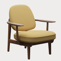 The Fritz Hansen Fred Lounge Chair in Acca fabric showcases a modern design with yellow cushioned seat and backrest, complemented by wooden armrests and legs, presented against a plain white background.