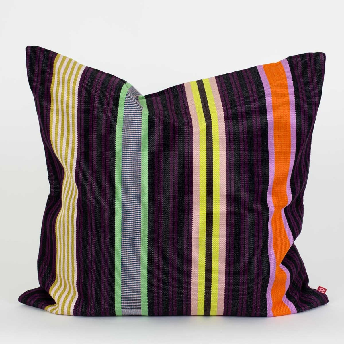 The Hana Cushion by World Of Craft is a square, handwoven piece crafted by a Guatemalan artisan, featuring black and purple stripes with colorful vertical accents in yellow, green, white, orange, and lavender on one side. It is photographed against a plain white background.