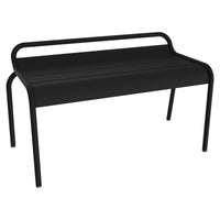 The Fermob Luxembourg Compact Bench is a modern black metal outdoor bench featuring a curved backrest and a sleek, minimalist design. Inspired by classic French style, it has four straight legs and a smooth, flat seat—making it an ideal choice for contemporary outdoor spaces.