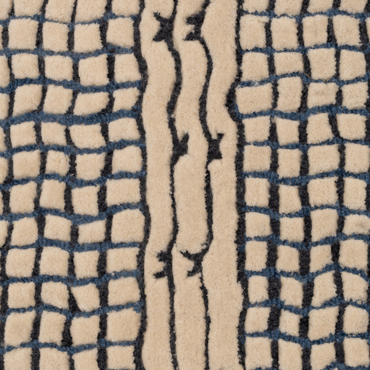 Ligne Roset Katagami rug in hand-tufted New Zealand wool, featuring a cream-colored background with black bouclé grid patterns on the sides and a central stripe with abstract, wavy lines.
