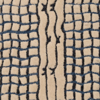 Ligne Roset Katagami rug in hand-tufted New Zealand wool, featuring a cream-colored background with black bouclé grid patterns on the sides and a central stripe with abstract, wavy lines.