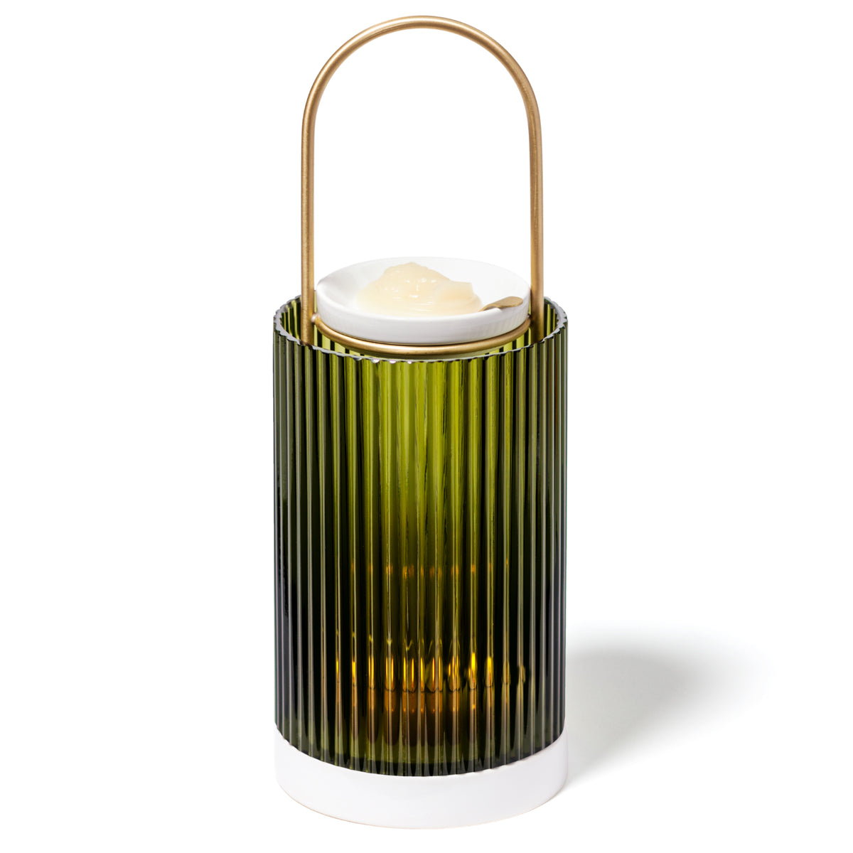 A green, ribbed glass Trudon La Promeneuse lantern with a gold handle and a white base, holding a scented wax cameo on a white ceramic dish.