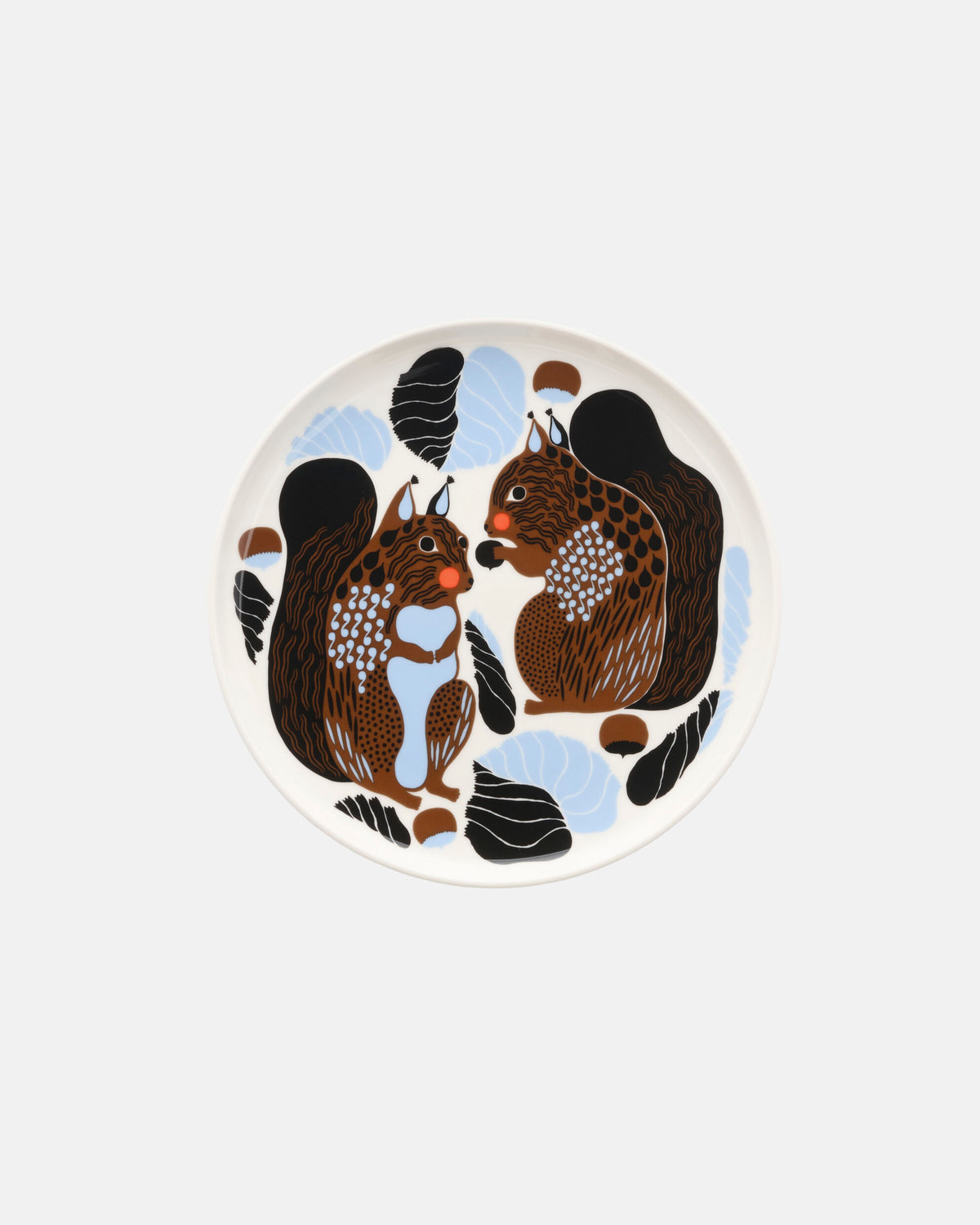 The Marimekko Oiva / Kurre Plate 20cm showcases two brown and black squirrels facing each other, surrounded by blue leaves, black acorns, and abstract patterns on a white ceramic background—a charming forest-inspired design from the Christmas Edition 2026.
