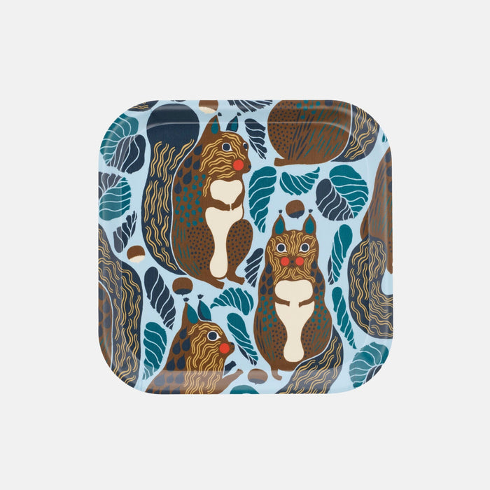 The Marimekko Kurre Tray is a rectangular serving tray made from high-quality birch plywood, featuring a vibrant pattern of brown squirrels and blue leaves on a light background—ideal for presenting treats during the Christmas Edition 2026.