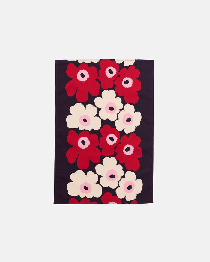 A rectangular Marimekko Unikko Kitchen Towel featuring a striking floral pattern with large red, white, and pink flowers arranged in vertical rows on a dark background.