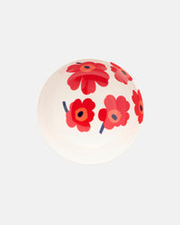 The Marimekko Oiva / Unikko Bowl 1.3l is a white serving bowl decorated with the iconic Unikko floral pattern, showcasing bold red and pink flowers with dark centers. The bowl is shown from an angled top view against a plain light background.