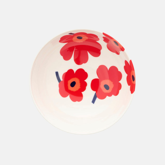 The Marimekko Oiva / Unikko Bowl 1.3l is a white serving bowl decorated with the iconic Unikko floral pattern, showcasing bold red and pink flowers with dark centers. The bowl is shown from an angled top view against a plain light background.