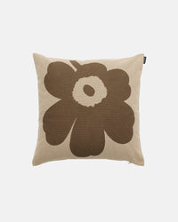 A Marimekko Unikko Cushion Cover in beige, featuring a large, stylized brown flower motif at the center, crafted from soft recycled cotton and displayed on a plain white background.