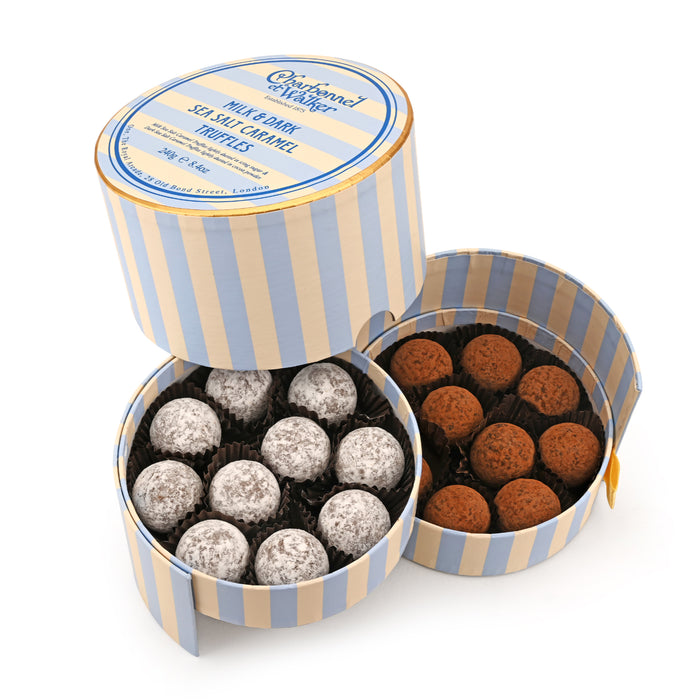A round, blue-and-white striped Charbonnel & Walker Milk and Dark Sea Salt Caramel Truffles, 240g gift box containing a layer of milk truffles and a layer of cocoa-dusted dark truffles.