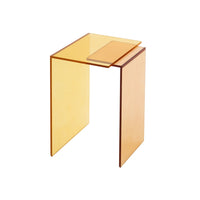 The Patchs Occasional Table by Ligne Roset is a modern, amber-colored acrylic side table with clean lines and a rectangular shape, featuring a raised accent surface on one side for added contemporary appeal.