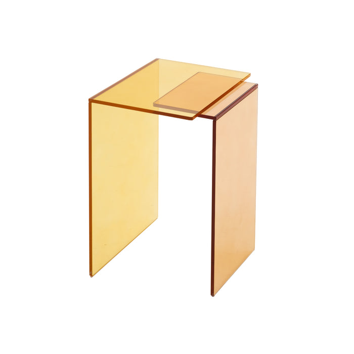 The Patchs Occasional Table by Ligne Roset is a modern, amber-colored acrylic side table with clean lines and a rectangular shape, featuring a raised accent surface on one side for added contemporary appeal.