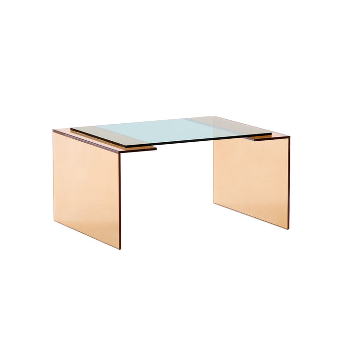 The Patchs Low Table by Ligne Roset features a modern, minimalist design with a clear, green-tinted glass top and two solid, rectangular light brown sides, offering a contemporary aesthetic reminiscent of a tempered glass table.