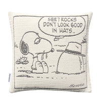 Maison Deux Peanuts Cushion featuring a line drawing of Snoopy looking at a rock wearing a hat, with a speech bubble that reads, SEE? ROCKS DONT LOOK GOOD IN HATS..