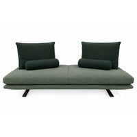 The Ex-Display Prado Medium Sofa by Ligne Roset, upholstered in Alcantara, features two generous square back cushions and two cylindrical bolsters, sleek black metal legs, and a minimalist design inspired by the adaptable settee concept—all presented against a white background.