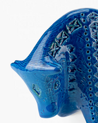A close-up of Bitossi's Bull Figure, a glossy blue ceramic sculpture in the Rimini Blu style with geometric patterns and raised textures, reminiscent of the brand’s iconic mid-century animal designs.