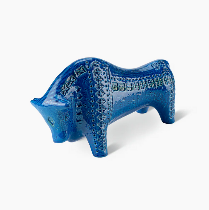 The Bitossi Bull Figure is a blue ceramic figurine with geometric patterns and textured detailing, inspired by Rimini Blu, displayed on a plain white background.