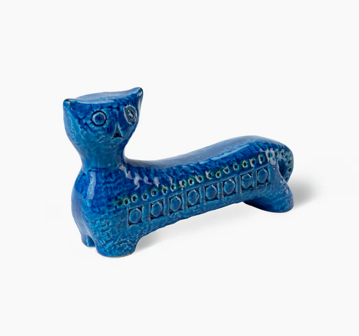 The Bitossi Long Cat Figure is a blue ceramic figurine with a textured finish, circular side patterns, and elongated body—an iconic mid-century design.