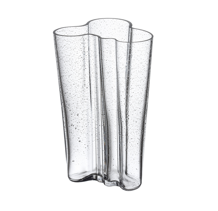 The Alvar Aalto Bubble Vase features clear glass with wavy edges, an organic form, and small bubbles throughout the design by Alvar Aalto, shown against a white background.
