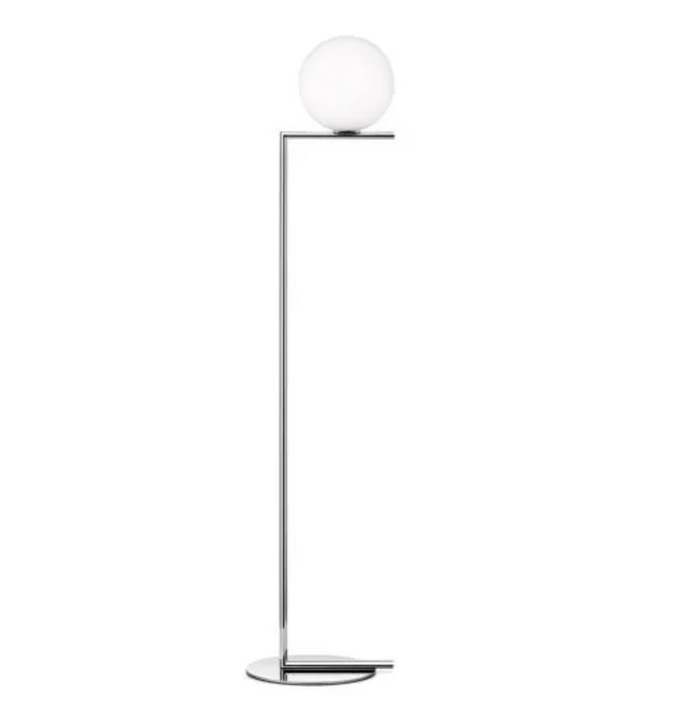 The Flos IC Floor Lamp, F1 features a modern design with a slim chrome stand and a round white frosted glass globe atop a sleek flat circular base.