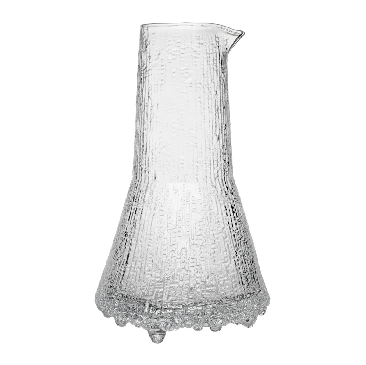 The Ultima Thule Pitcher 50cl Clear is a Nordic-inspired glass pitcher with a wide base, narrow neck, and spout. Its clear textured surface features vertical lines and bubble-like details reminiscent of classic Iittala designs.