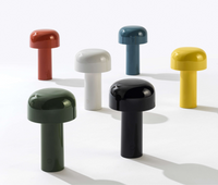 Six contemporary Bellhop Portable Lamps by Flos in red, white, blue, yellow, green, and black are displayed on a white background. Each glossy IP54 rechargeable lamp features a sleek cylindrical design for stylish cordless lighting.