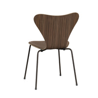 The Series 7 Chair, Front Upholstered in Technicolor Fabric by Fritz Hansen showcases modern Danish design with its curved backrest and seat inspired by Arne Jacobsen’s iconic style, supported by four slender black metal legs and photographed against a plain white background.