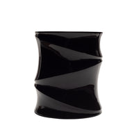 A glossy black cylindrical occasional table named the Simeti, featuring a striking twisted, spiral design by Ligne Roset. Handcrafted in Vietnam with a stunning glossy lacquer finish, it is showcased against a plain white background.