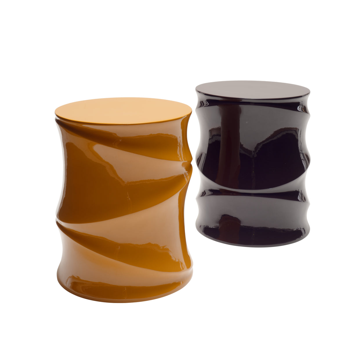 Two glossy, cylindrical Simeti Occasional Tables by Ligne Roset—one in mustard yellow and the other in dark purple—stand side by side against a white background. Handcrafted in Vietnam with a lustrous lacquer finish and featuring unique twisted designs, these eye-catching tables make a bold statement in any space.