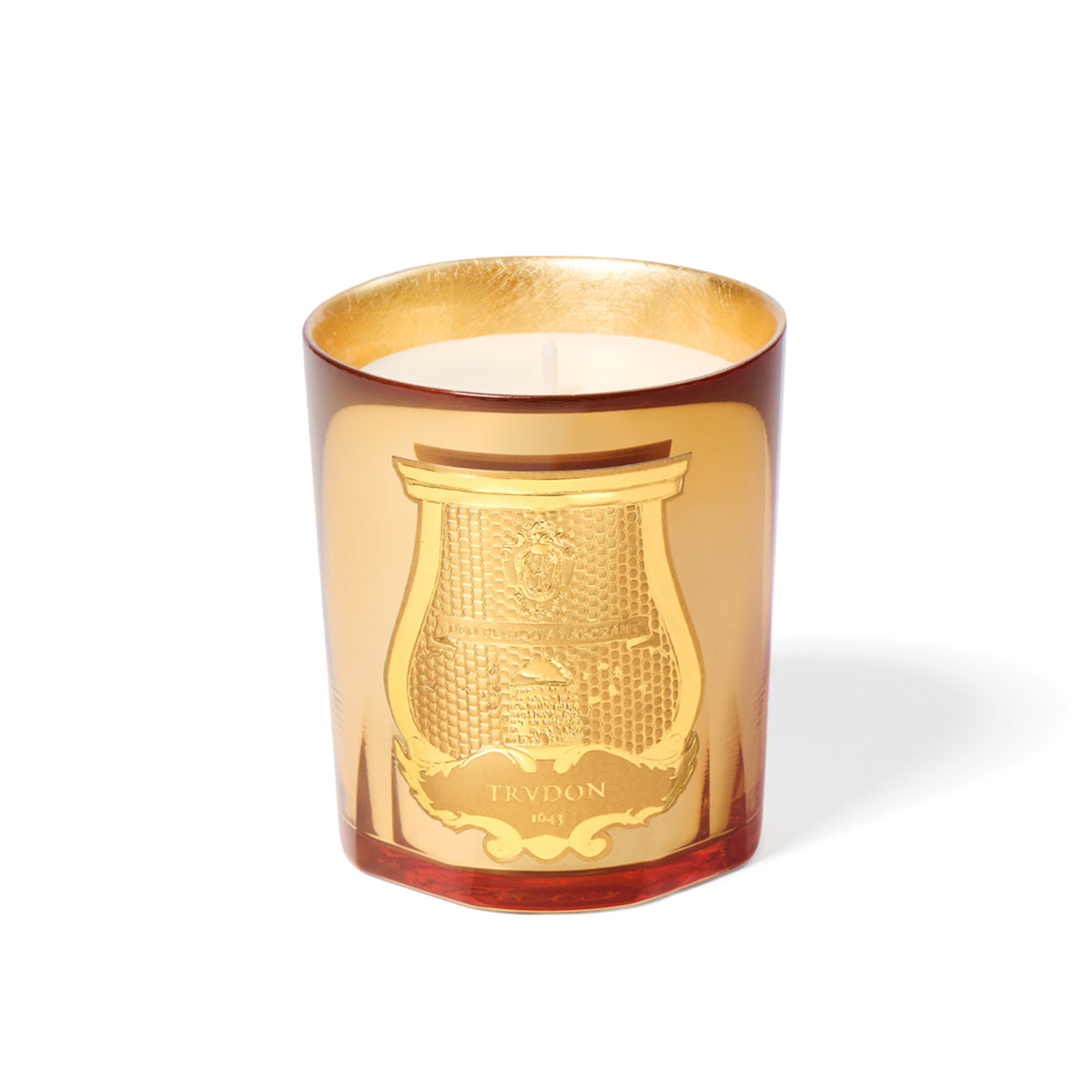 Trudon Holiday Candle 270g in a red glass vessel with a gold-colored interior and a decorative gold embossed label on the front.