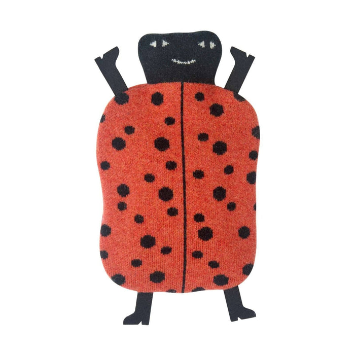 The Donna Wilson Ladybird Hot Water Bottle features a soft, plush design with a red, black-spotted body, a smiling black head, and black arms and legs. It is shown lying on a white background.