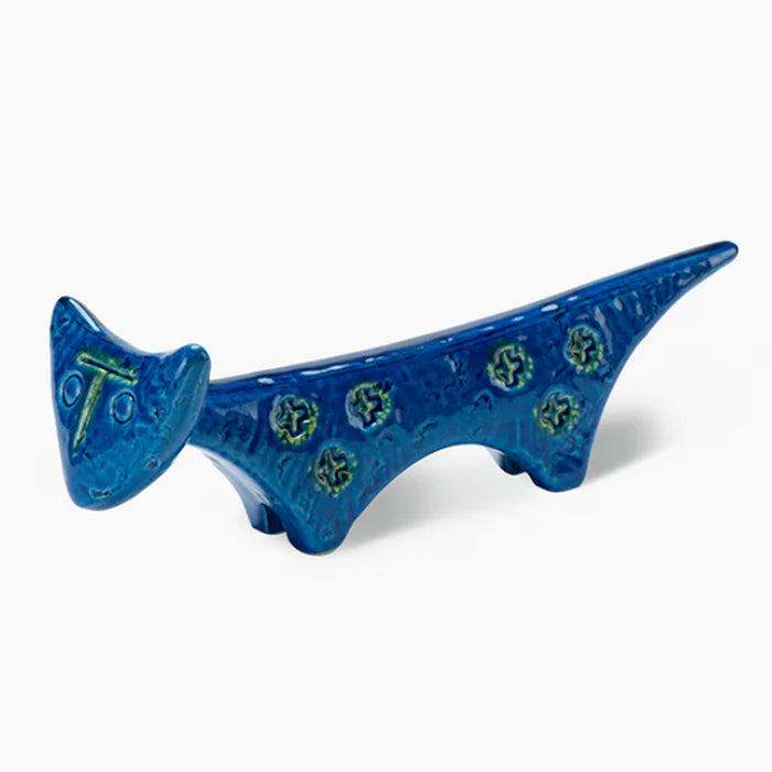 The Bitossi Cat Figure is a blue ceramic figurine featuring a long body, short legs, green circles along its side, and a glossy finish—an elegant tribute to Rimini Blu mid-century style.