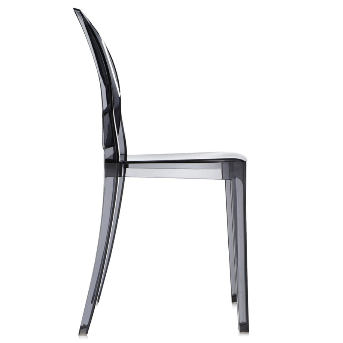 Side view of the Ex-Display Victoria Ghost Chair by Kartell, featuring a modern, transparent design with a curved backrest and straight seat reminiscent of Philippe Starck’s iconic creation. The chair is crafted from clear or smokey acrylic or plastic material.