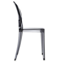 Side view of the Ex-Display Victoria Ghost Chair by Kartell, featuring a modern, transparent design with a curved backrest and straight seat reminiscent of Philippe Starck’s iconic creation. The chair is crafted from clear or smokey acrylic or plastic material.