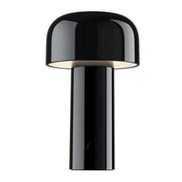 The Flos Bellhop Portable Lamp, IP54, is a modern black rechargeable table lamp with a dome shade, cylindrical base, glossy finish, and minimalist design—wireless and inspired by contemporary style, shown isolated on a white background.