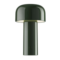 The Flos Bellhop Portable Lamp, IP54, features a modern dark green design with a cylindrical base and mushroom-shaped shade, offering stylish cordless lighting in a rechargeable table lamp.